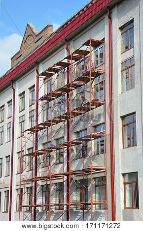 Old town reconstruction. Stucco and Painting with Scaffolding Works During Exterior Wall Renovations and Repair.