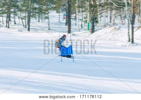 Irkutsk, Russia - February 12, 2017: Slalom competition snowboarding and skiing for adults and children in Irkutsk on the ski base in Akademgorodok Academy Cup in 2017