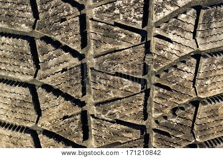 Dirty winter tyre tread close up background