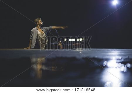 Teen Dancer In Casual Cloth Sitting On The Strret