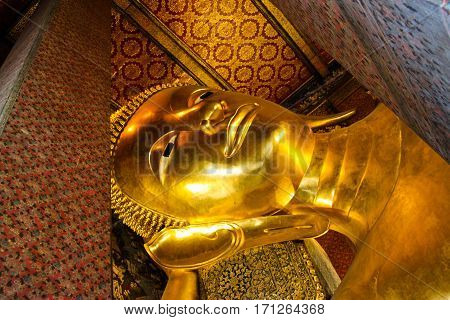 The Big golden Reclining Buddha at Wat Pho in Bangkok Thailand.