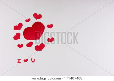 Red hearts on a white background. I Love You card concept with copy space Valentine's day theme. Shot from above