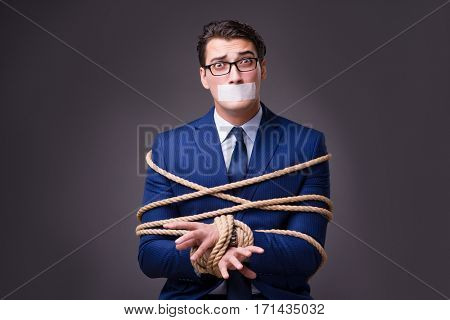Businessman taken hostage and tied up with rope
