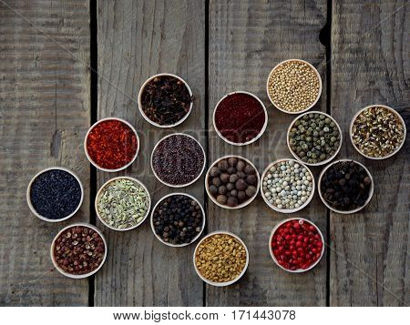 Spices On A Wooden Background. Coriander, Black Pepper, Paprika, Mustard, Turmeric, Cumin, Sumac, Fe