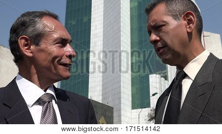 Business Men Having Conversation Outside of Office Building