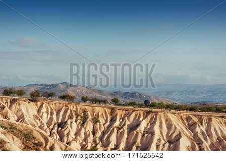 Beauty geological formations in Cappadocia, Turkey. Cappadocia with its valley, ravine, hills, located between the volcanic mountains in Goreme National Park.