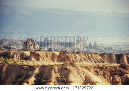 Beauty geological formations in Cappadocia, Turkey. Cappadocia with its valley, ravine, hills, located between the volcanic mountains in Goreme National Park.