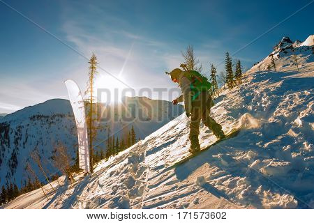 Freeride Snowboarder Slides Down A Steep Slope At Dawn