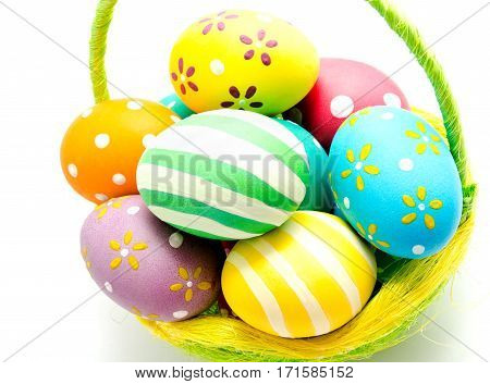 Perfect colorful handmade easter eggs in the basket isolated on a white