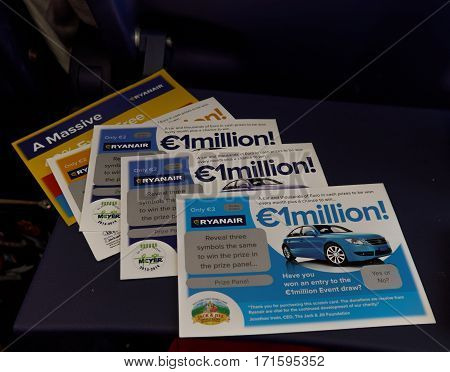Girona, Spain - September 23 2016: Ruanair Scratch cards on a plane seat table.
Sold inside aircrafts during flights with donations given to charities the airline decides.
