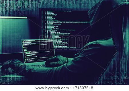 Internet concept. Hacker working on a code on dark digital background with digital interface around.