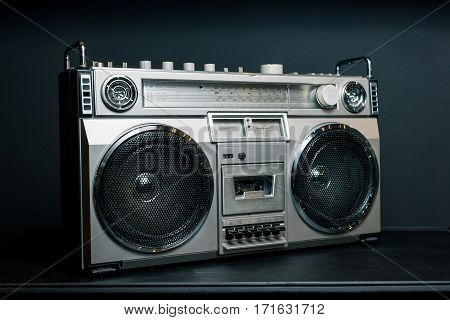 Vintage radio boombox on dark background .