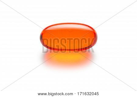 Orange gelatin capsule or pill isolated on a white background. Medically themed studio macro with backlighting for extra pop.