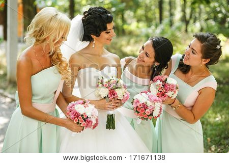 Bridesmaids admiring of bride on the street