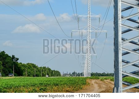 Transmission Tower On A Background Field Of Soybeans