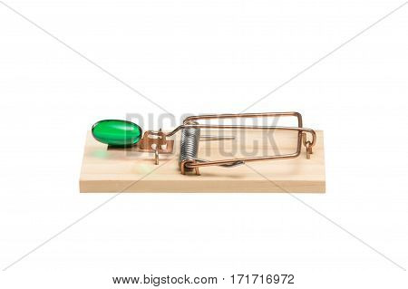Green gelatin capsule or pill as bait in a mousetrap. Studio close-up isolated on white. Concepts could include addiction desire danger risk others.