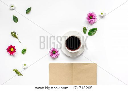 Froral flat lay with cup of coffee and craft notepaper on white background top view mockup