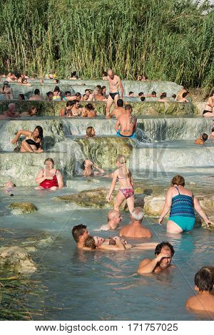 SATURNIA ITALY - August 24 2015: tourists swimming and relaxing in hot springs in Saturnia at Mulino this spa world famous has natural waterfalls near the city of Manciano in tuscan