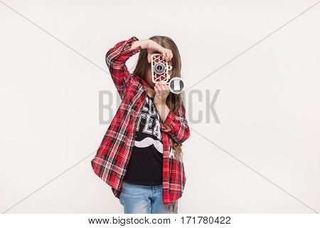 Beautiful little girl holding a instant camera. Fashion kid taking pictures with retro camera isolated on white background