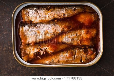 Tinned sardines in tomato sauce on the slate closeup horizontal