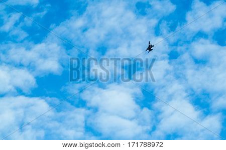 Distant View Of A War Plane Flying In Blue Sky