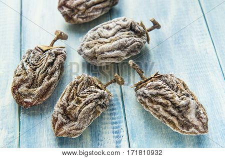 Dried persimmon on blue wooden background