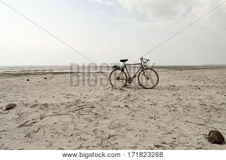 Red and white racing bike on the white sand of bamburi beach in Mombasa Kenya