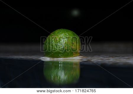Reflection of a tiny lemonsito (kalamansi) in water, Panglao, Philippines