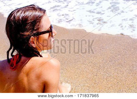 yong woman after sweeming in sea on the beach have a tan