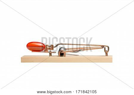 Orange gelatin capsule or pill as bait in a mousetrap. Studio close-up isolated on white. Concepts could include addiction desire danger risk others.
