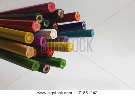 A bunch of colored pencils on white background.