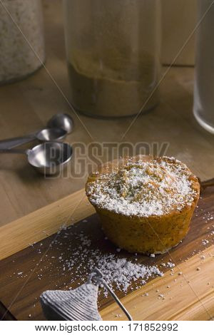 A delicious lemon poppy seed muffin on a wooden board