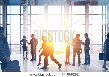 People silhouettes in an office hall with panoramic windows. They are talking walking and going to their workplaces. 3d rendering. Toned image. Double exposure.