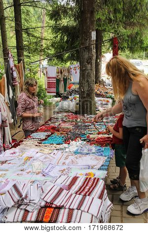 Schodnica Ukraine - June 30 2014: People near trade stalls with ukrainian souvenirs