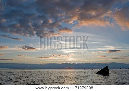 Beautiful sunset over the sea. Rock Moby Dick.
