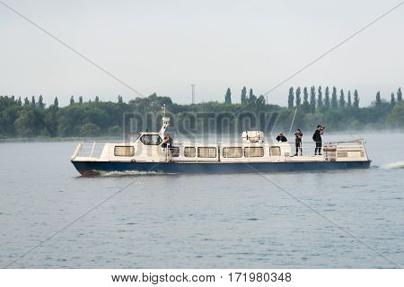Kurchatov, Russia - JUNE 23, 2016: Reporters sail on a pleasure boat on the reservoir of Kursk NPP. Foggy morning.