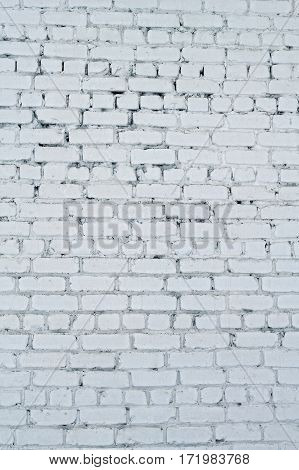 Old white concrete wall with cracks. Textured background