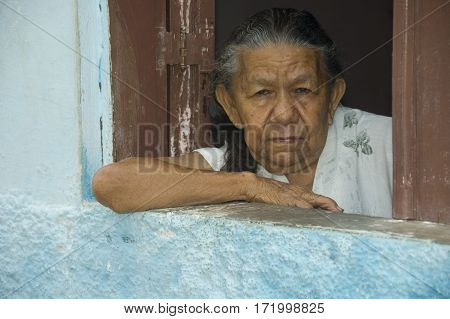 Brazil Fortaleza 05-03-2008: Old Brazilian woman in window