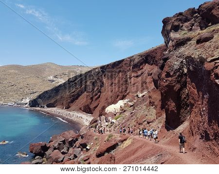 Group Of People Walking Towards Red Beach, Santorini, Greece.