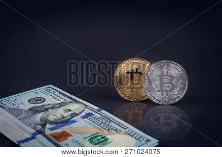 Bitcoins Lie On A Dark Background With Dollars Close-up