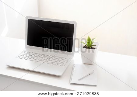Completely White Modern Workspace With Laptop, Notepad, Plant And Pen. Minimal Pure Consept