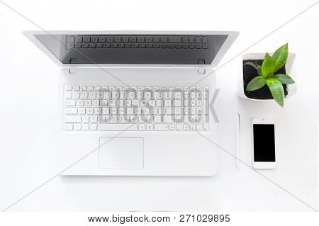 Completely White Modern Workspace With Laptop, Notepad, Plant And Pen. Minimal Pure Consept