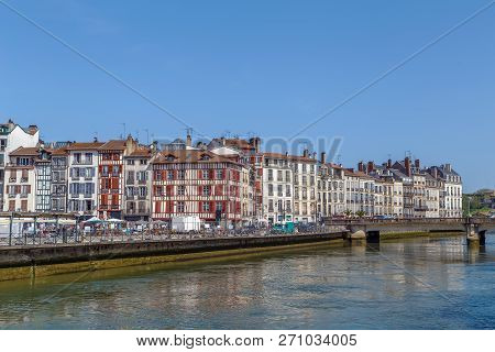 Nive River Embankment With Historical Houses In Bayonne, France