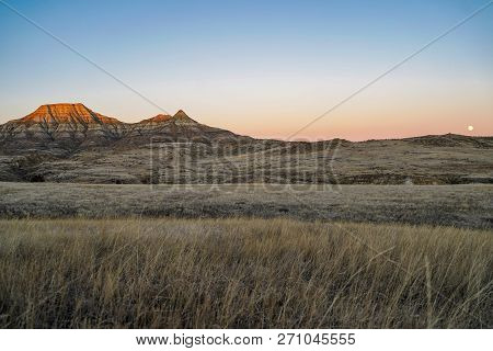 Alpenglow On Badlands Mountain Cliffs In Eastern Montana During Sunrise, Near Miles City, Mt