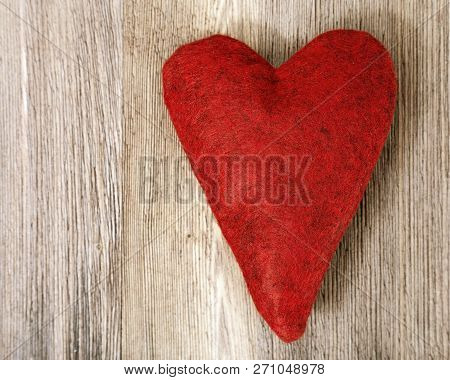 Red Fleece Heart On Natural Wood Surface. Soft Toy Heart. Top View. Copy Space. Romantic Background.