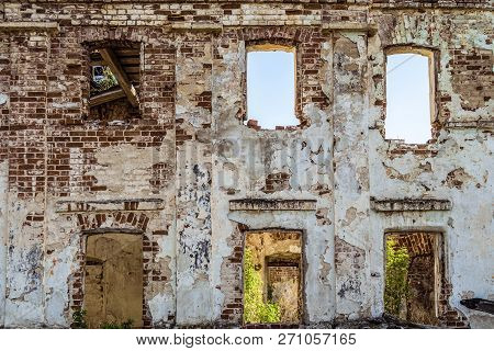 Brick Wall With Window Openings Of Old Abandoned Dilapidated Historical Residential Building