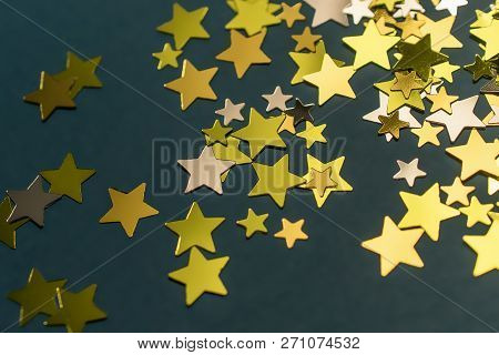 Golden Confetti Stars Scattered On The Surface.