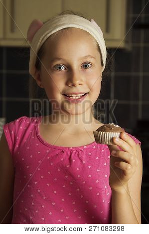 Cute Little Girl Cooking Muffins At Kitcen. Close Up Portret.