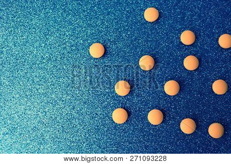 Small Yellow Orange Beautiful Medical Pharmaceptic Round Pills, Vitamins, Drugs, Antibiotics On A Bl