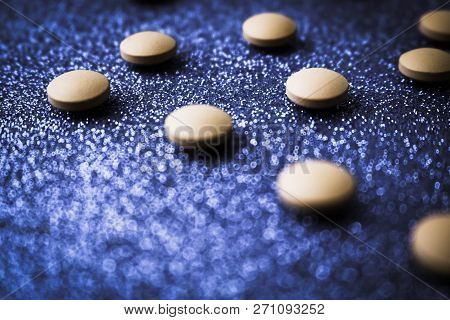 Small Yellow Orange Beautiful Medical Pharmaceptic Round Pills, Vitamins, Drugs, Antibiotics On A Bl